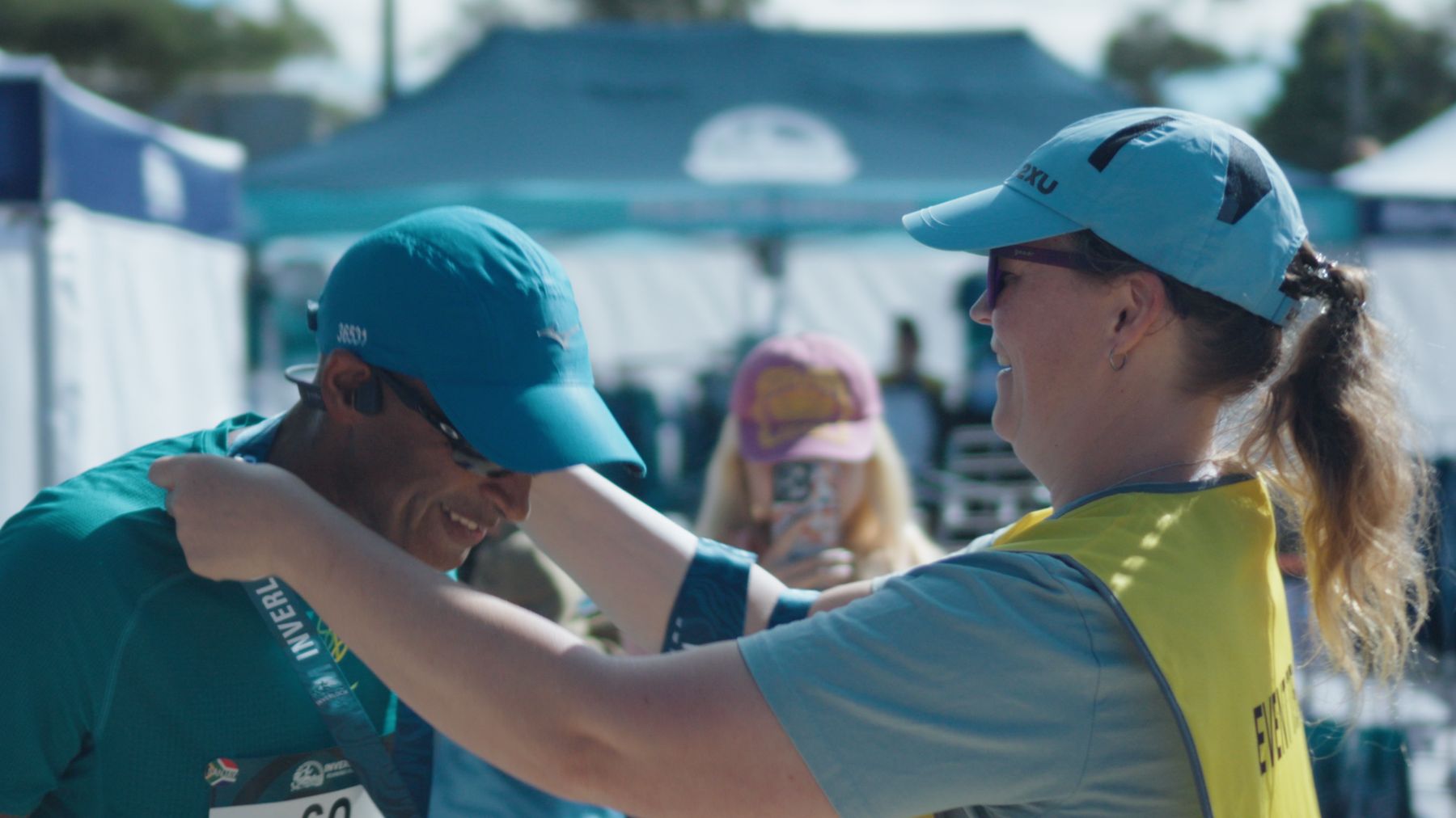 Volunteer helping a runner at the finish
