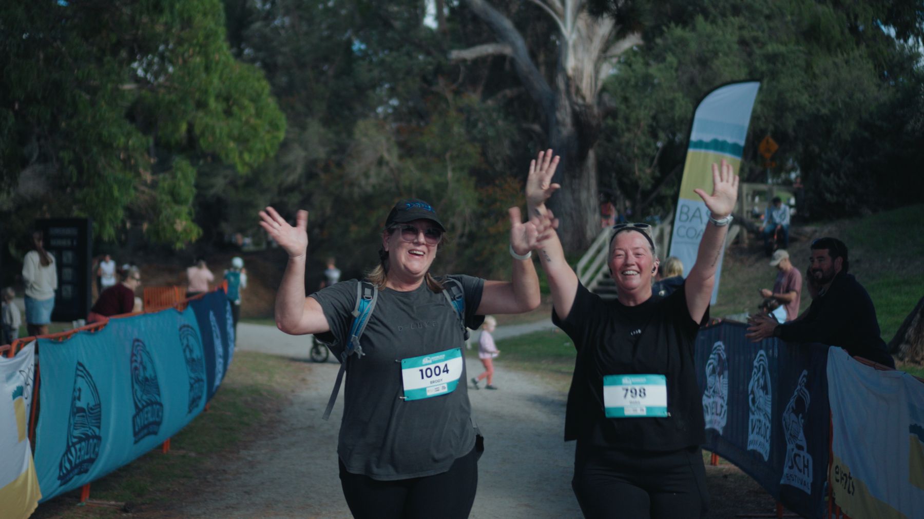 Two runners high-fiving at the finish