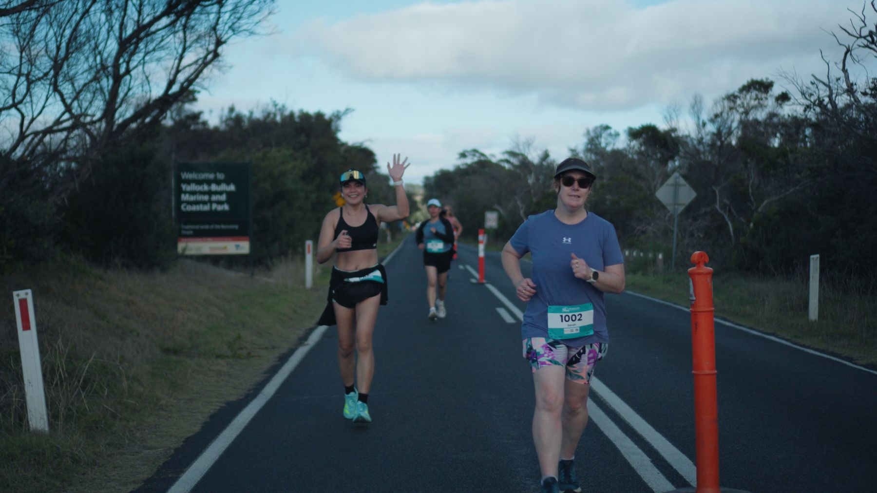 Runners passing the Yallock-Bulluk Marine and Coastal Park sign