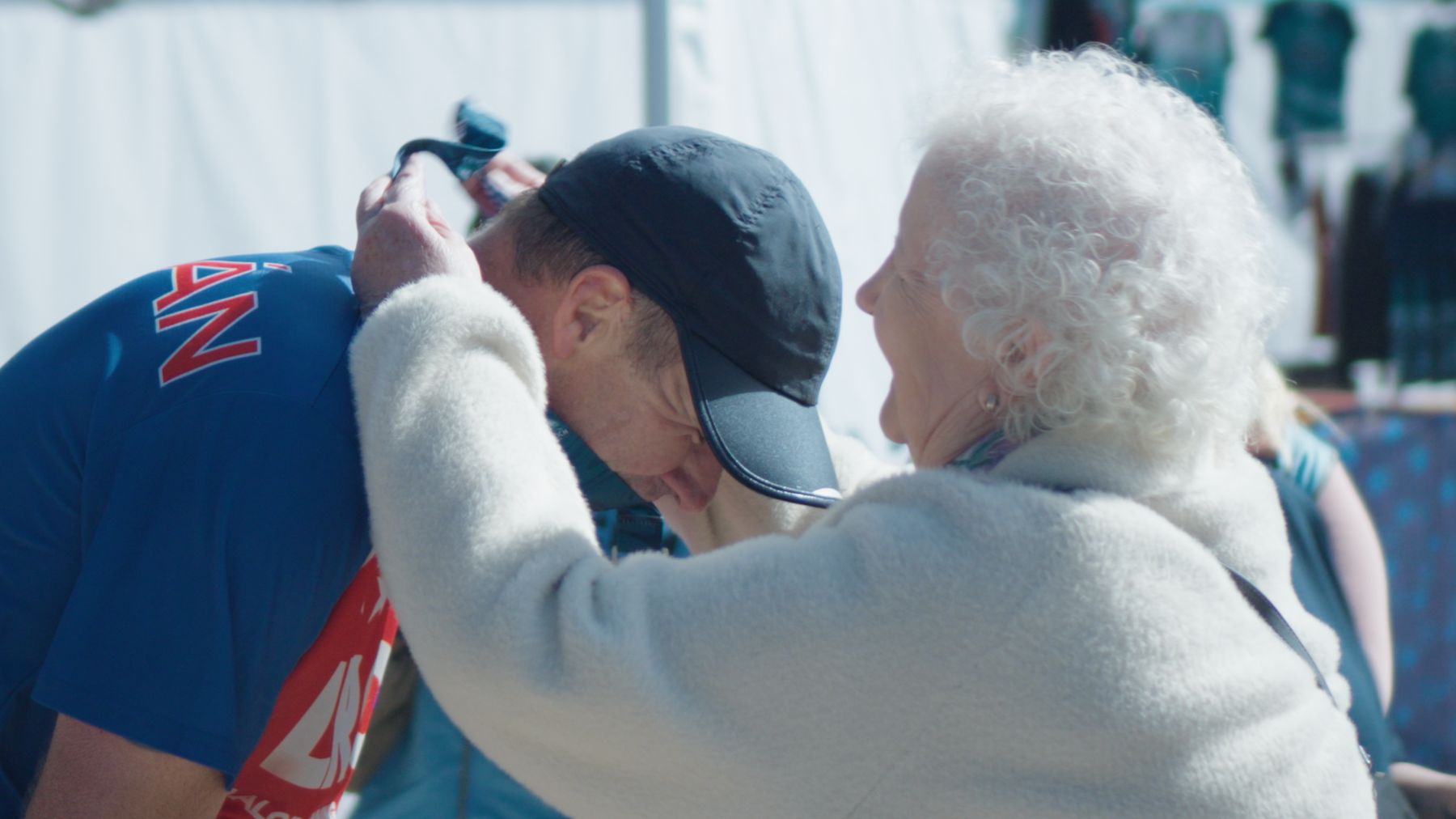 A finisher embraced by a family member